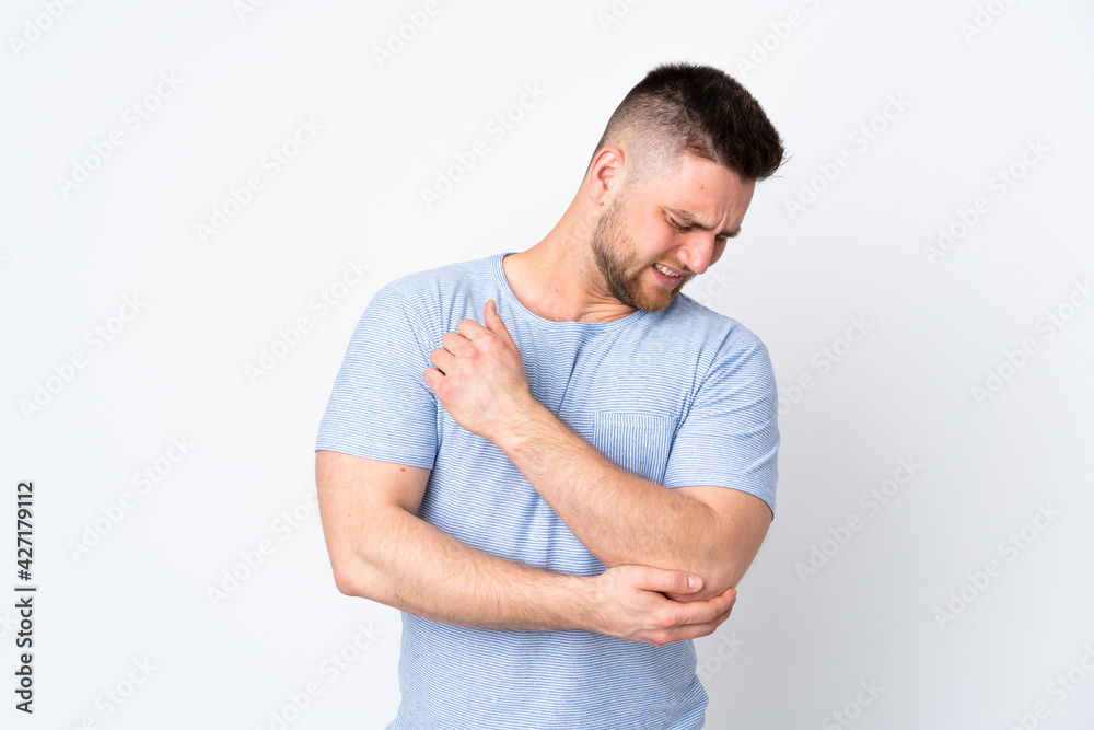 Russian handsome man over isolated background with pain in elbow Russian handsome man over isolated background with pain in elbow