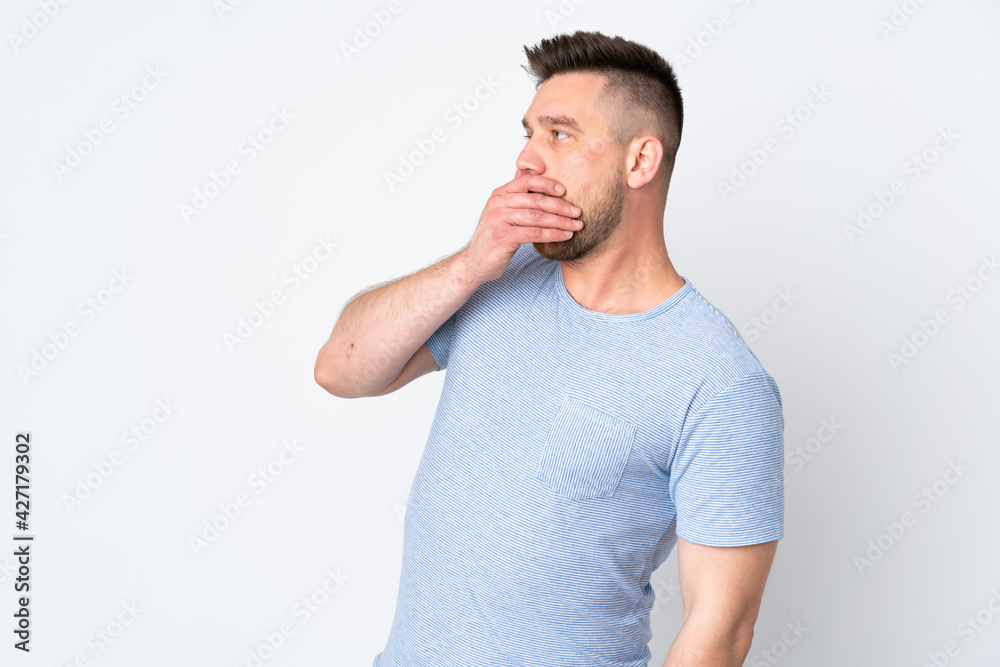 Russian handsome man over isolated background doing surprise gesture while looking to the side Russian handsome man over isolated background doing surprise gesture while looking to the side