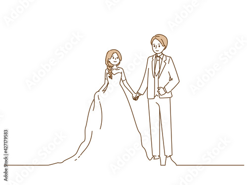 手をつなぐ新郎新婦
