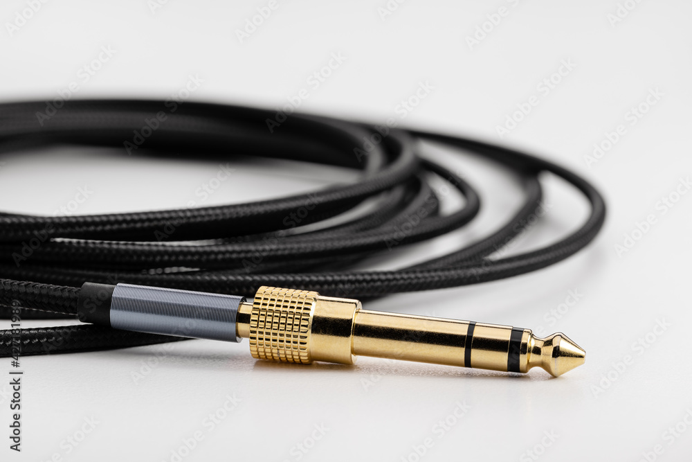 Black elastic wire, cable with plug and adapter, close-up. Black elastic wire, cable with plug and adapter, close-up.