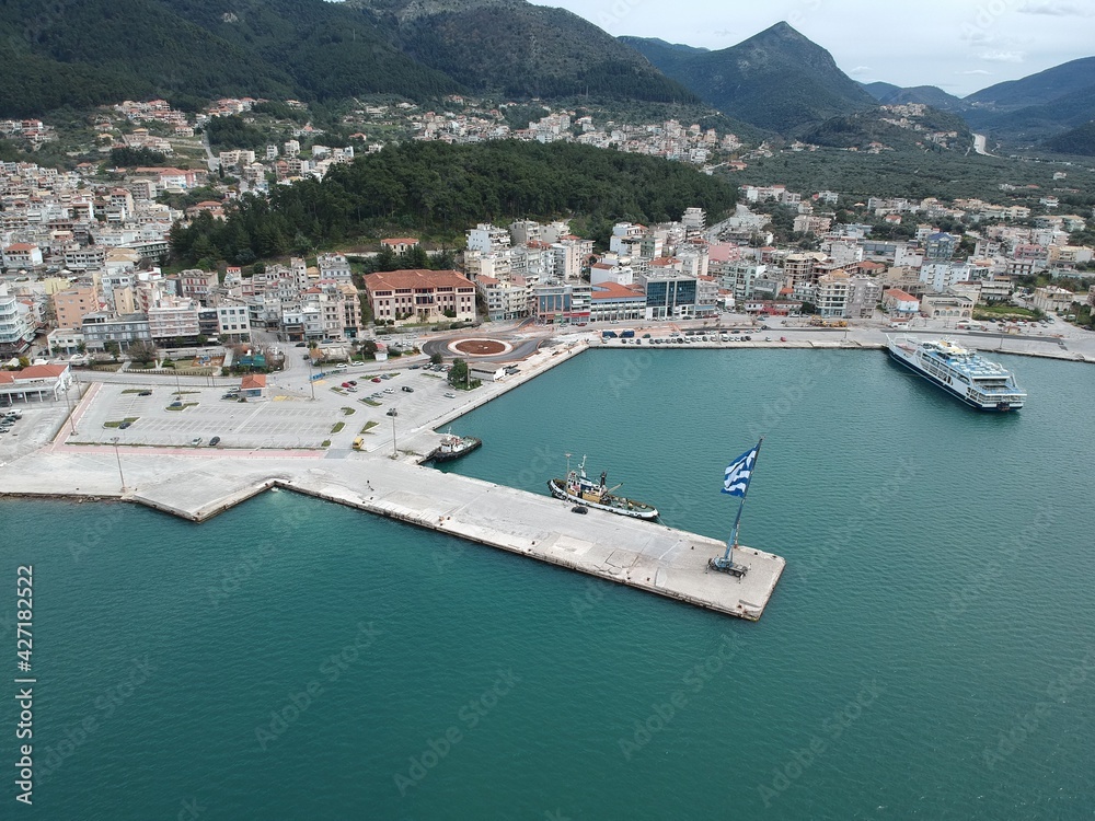huge greek flag waving in the port of igoumenitsa in greece during national holiday of greek revolution. 25 march