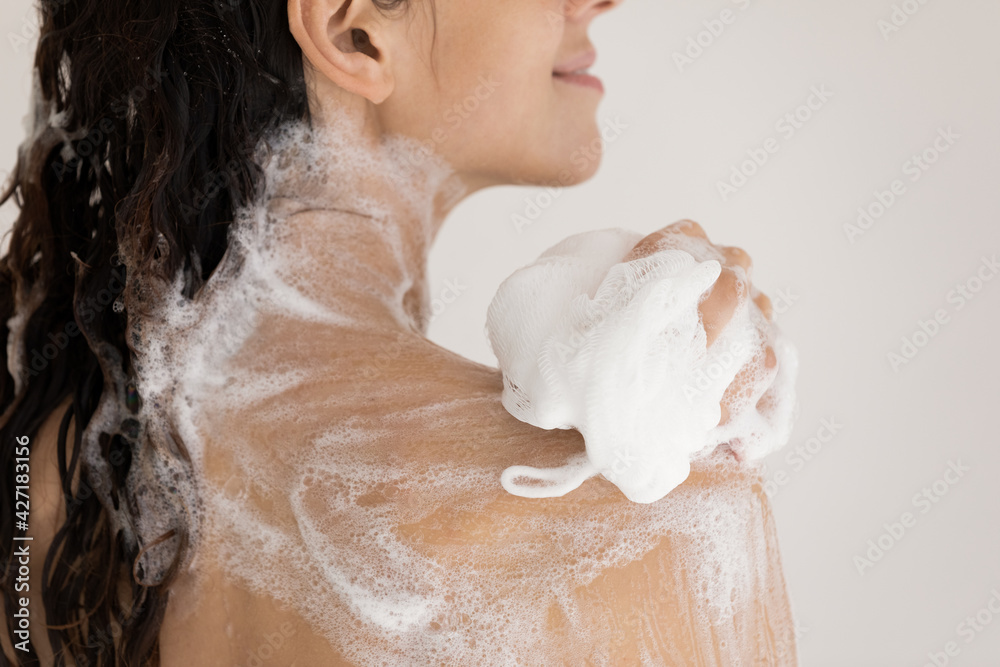 Close up beautiful woman taking shower with moisturizing soap, using ...