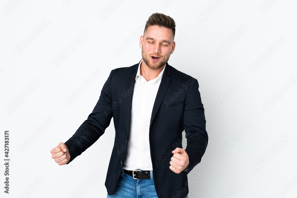 Fototapeta premium Young Russian business man isolated on white background celebrating a victory
