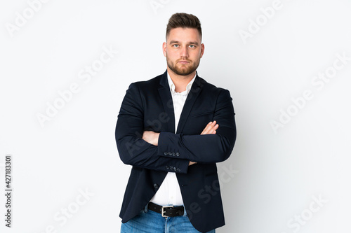 Young Russian business man isolated on white background keeping arms crossed