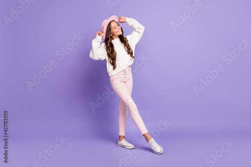 Full length photo of young attractive girl happy positive smile dream dreamy hands touch hat isolated over violet color background