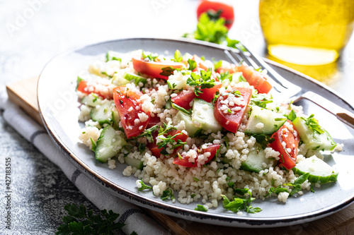 Traditional oriental salad Tabouleh. Tabule cous cous salad with vegetables. Tabbouleh with bulgur