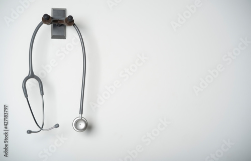 stethoscope equipment of doctor with is hanging on the white wall background