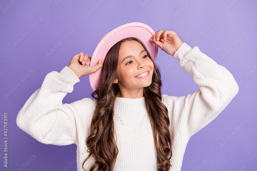 Portrait of brunette long hairdo sweet girl hands cap wear sweater isolated on violet color background Portrait of brunette long hairdo sweet girl hands cap wear sweater isolated on violet color background