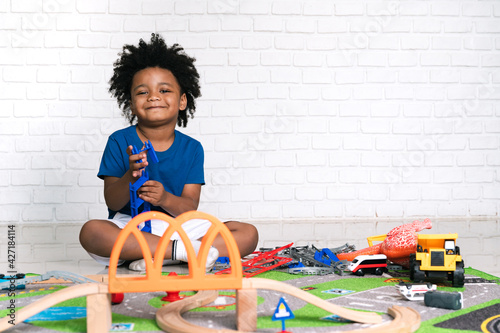 Happy black people African American child play toy at home 