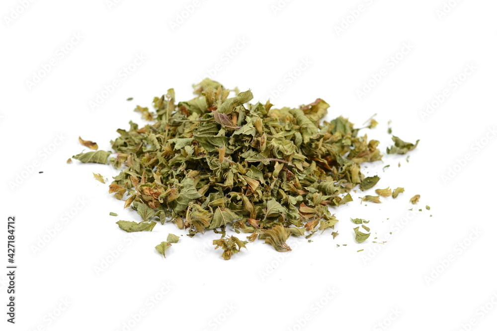 Dried lemon balm pile isolated on white background. Lemon balm spice. Bio organic lemon balm tea. Dried lemon balm pile isolated on white background. Lemon balm spice. Bio organic lemon balm tea.