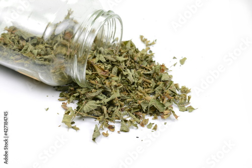 Dried lemon balm pile isolated on white background. Lemon balm spice. Bio organic lemon balm tea.