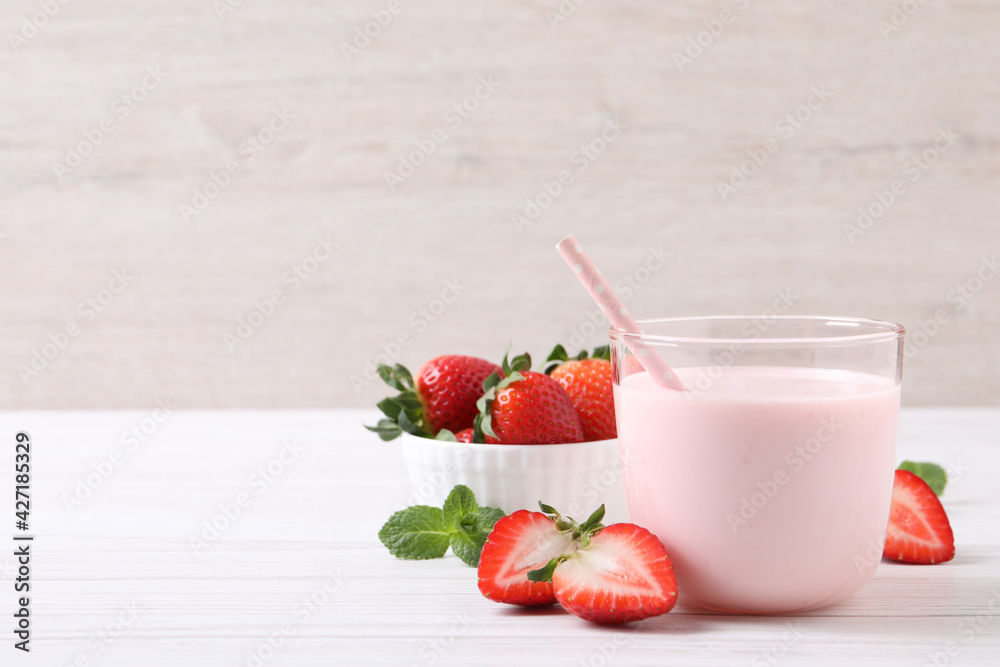 Delicious drink with strawberries on white wooden table, space for text Delicious drink with strawberries on white wooden table, space for text