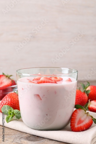 Delicious drink with strawberries on wooden table