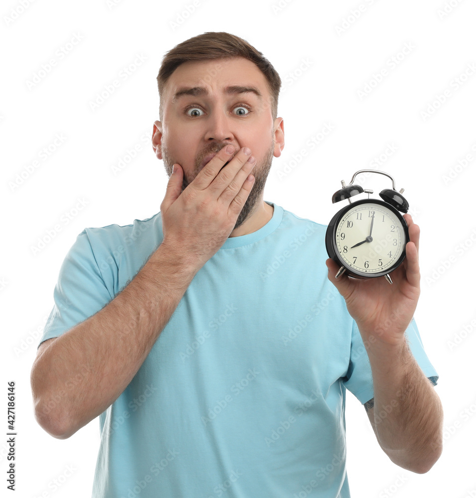 Emotional overslept man with alarm clock on white background. Being late concept Emotional overslept man with alarm clock on white background. Being late concept