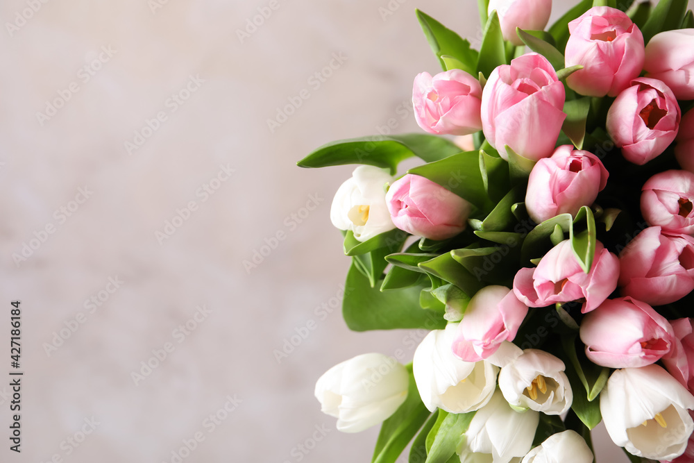 Beautiful bouquet of tulips against beige background. Space for text Beautiful bouquet of tulips against beige background. Space for text