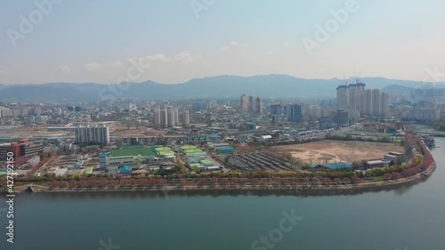 The huge river lake and buildings at the city. water is calm and skyscrapers are at the lands. The Beautiful drone aerial footage took with 4K 30fps.