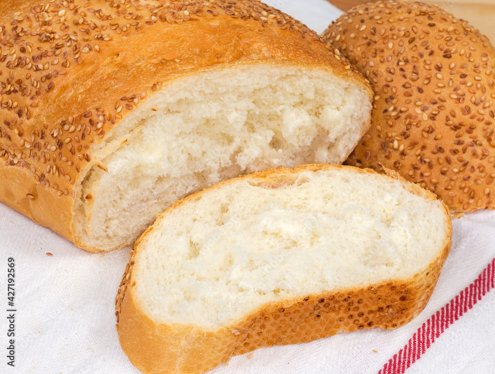 Pieces of wheat bread sprinkled with sesame on napkin Pieces of wheat bread sprinkled with sesame on napkin