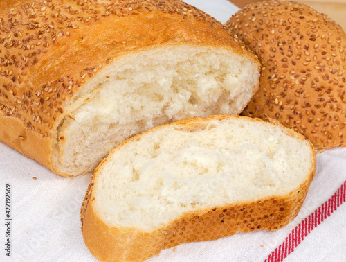 Pieces of wheat bread sprinkled with sesame on napkin