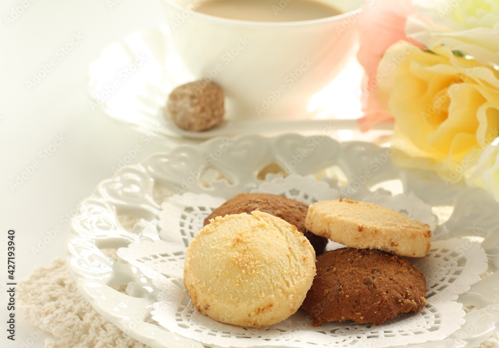 Homemade coffee and vanilla cookie with flower Homemade coffee and vanilla cookie with flower