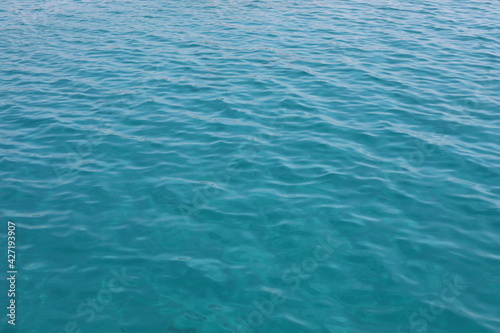 Blue water ripples. Wonderful swim in clean turquoise sea water. Scenic backdrop with beautiful transparent water of the Red Sea with sun shine.