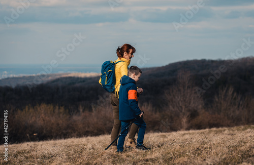 Mother and son hiking together in the mountains. 