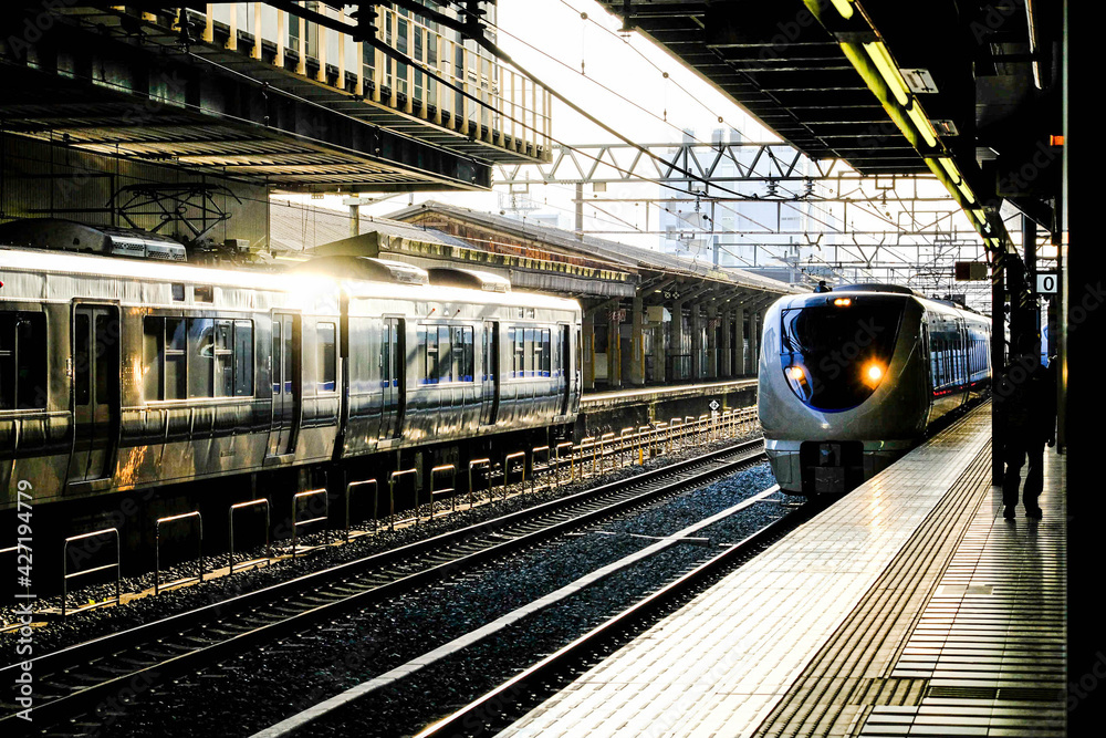 JR train railway station in evening, Sunshineing to train.JR train is parking on the track in the city in Japan.