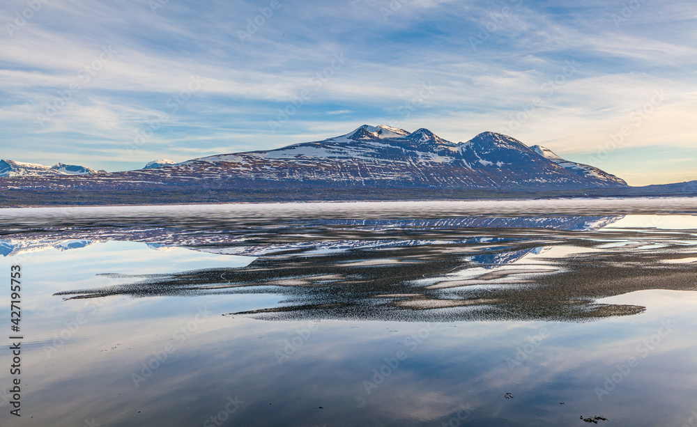 Landscape in spring with the lake Akkajaure covered with ice floes and the Akka mountain range in the background, Stora Sjöfallet National Park, Lapland, Sweden