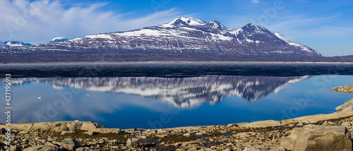 panoramic view on a landscape with the lake Akkajaure and the Akka mountain range reflecting in the water, Stora Sjöfallet National Park, Lapland, Sweden photo