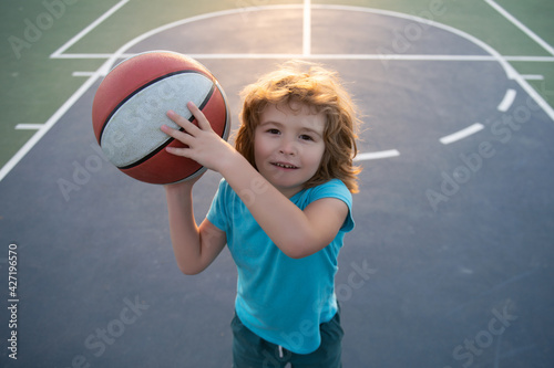 Cute child playing basketball. Sport for kids.