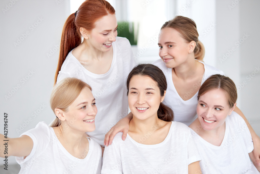 Portrait Of Young Mixed Race Women In Sportswear Posing At Camera In Fitness Studio Portrait Of Young Mixed Race Women In Sportswear Posing At Camera In Fitness Studio