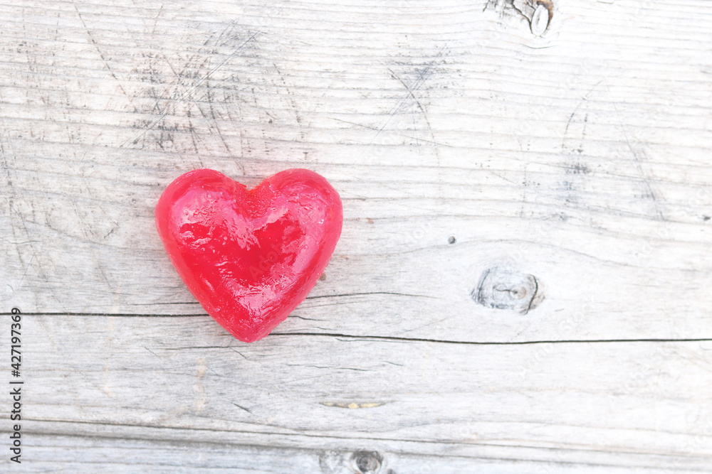 Red heart on natural wooden background as loving heart symbol for wedding greeting card with heart symbol or Valentine's Day card with beautiful red heart Red heart on natural wooden background as loving heart symbol for wedding greeting card with heart symbol or Valentine's Day card with beautiful red heart
