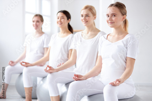 Gravid Women Sitting on Fitball In Yoga Pose, Preparing To Become Mother
