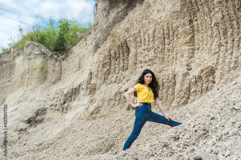 woman posing in background of mountain of sand, summer lifestyle