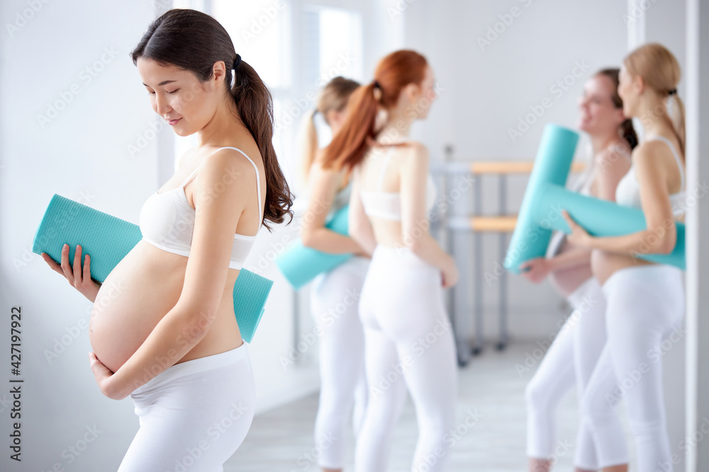portrait of asian pregnant woman with big tummy posing at camera portrait of asian pregnant woman with big tummy posing at camera