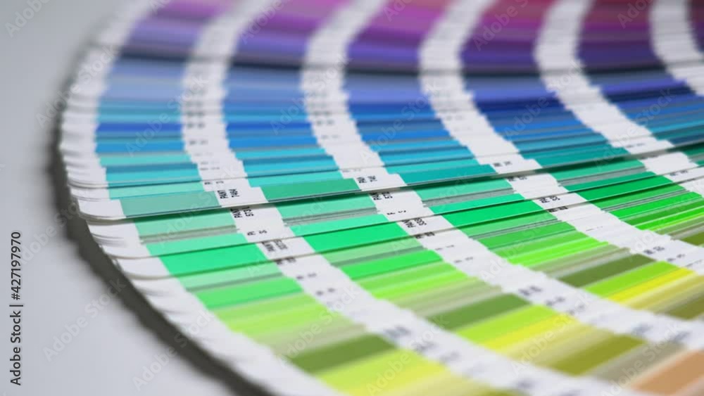 Close-up on color palette guide for printing and painting. Horizontal video of the catalog of color samples to be chosen for graphic, painting, printing a new creative business work. 