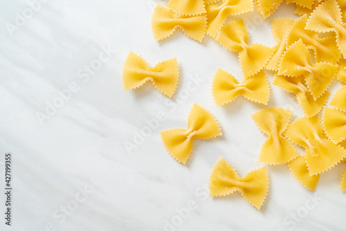 Dry uncooked farfalle pasta photo