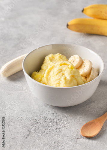 Banana homemade ice cream bowl with fruit, vegetarian concept food, copy space