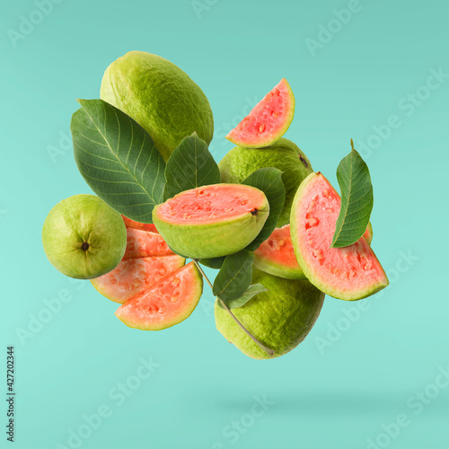 Fresh ripe guava falling in the air. Zero gravity concept photo