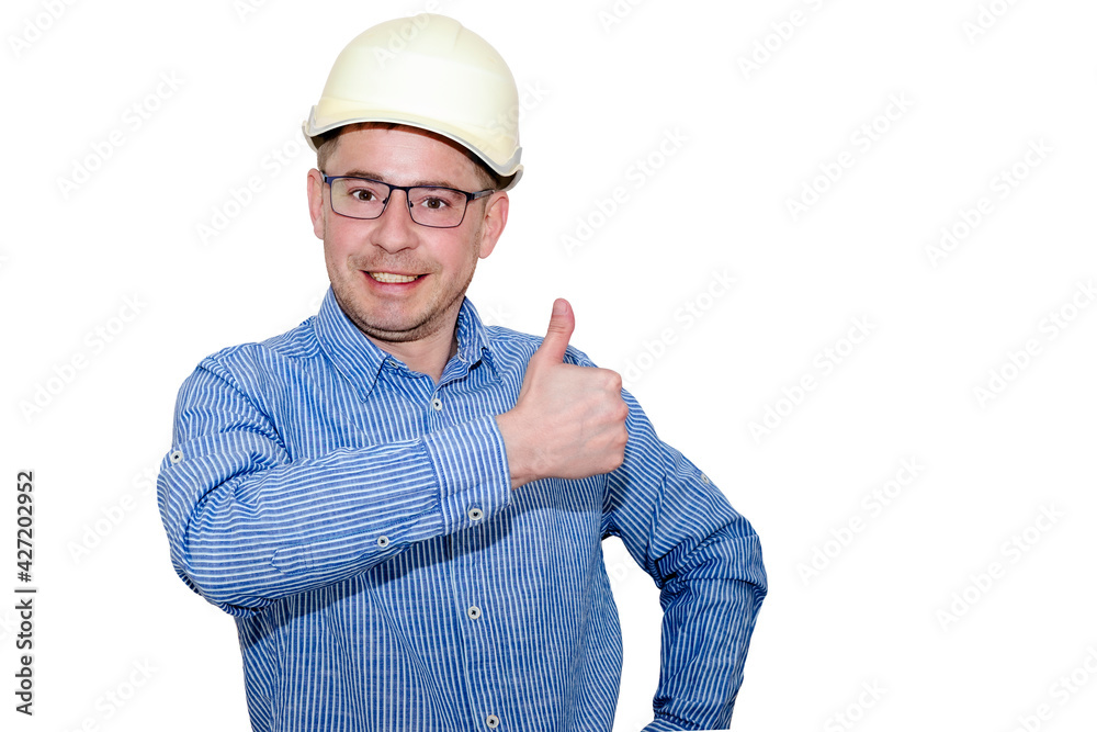 A man in a construction helmet and a blue shirt on a white isolated background with a raised hand shows a thumb. Brigadier. Builder. Engineer. Boss. A man in a construction helmet and a blue shirt on a white isolated background with a raised hand shows a thumb. Brigadier. Builder. Engineer. Boss.