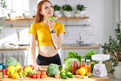 young woman with green apple in hands, posing at camera, healthy eating and diet concept