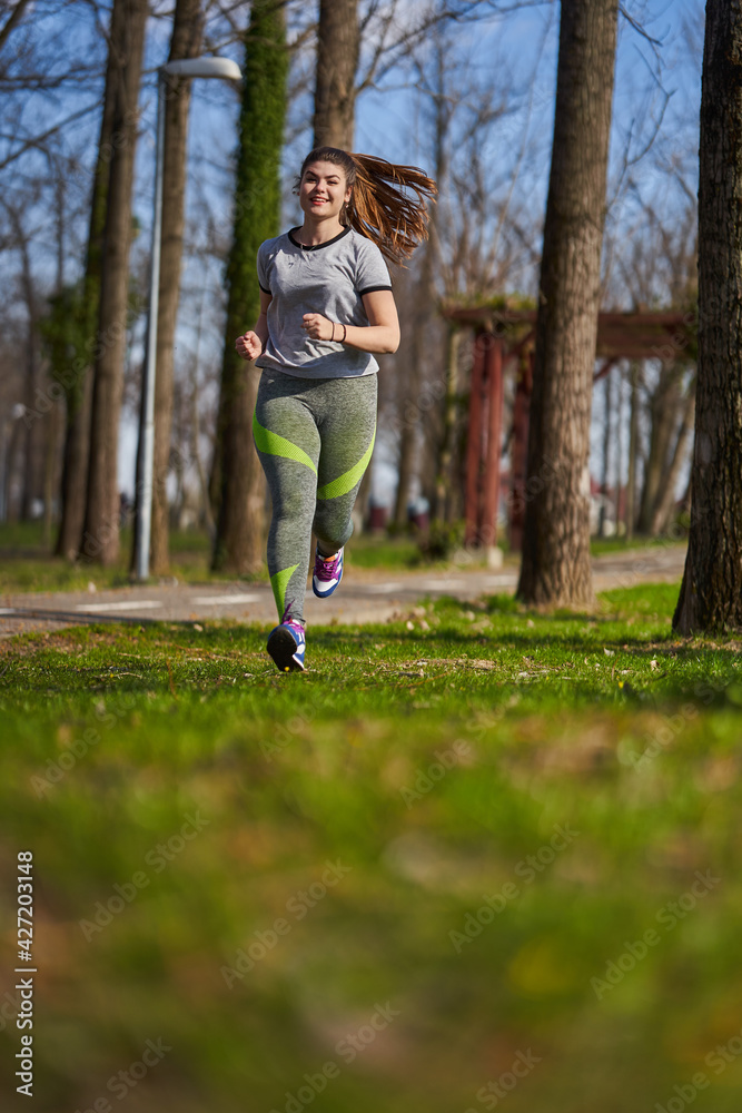 Plus size woman running in the park Plus size woman running in the park