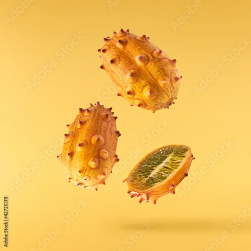 Fresh ripe kiwano falling in the air isolated photo