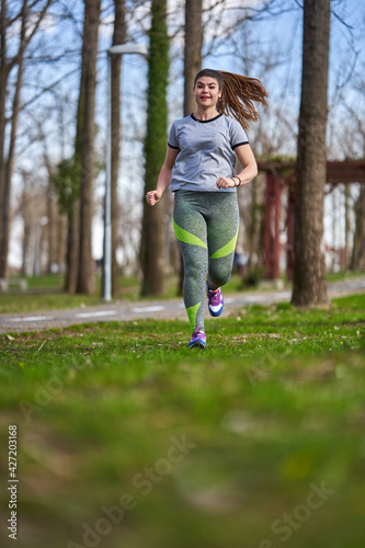 Plus size woman running in the park
