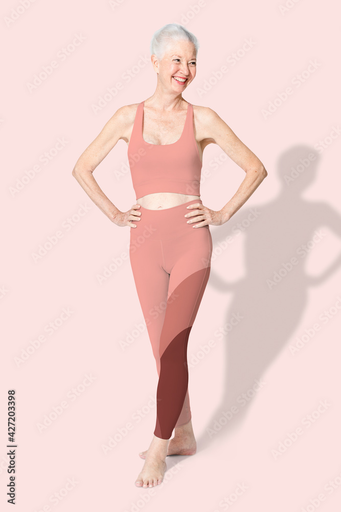 Healthy senior woman in pink sports bra and leggings full body Healthy senior woman in pink sports bra and leggings full body