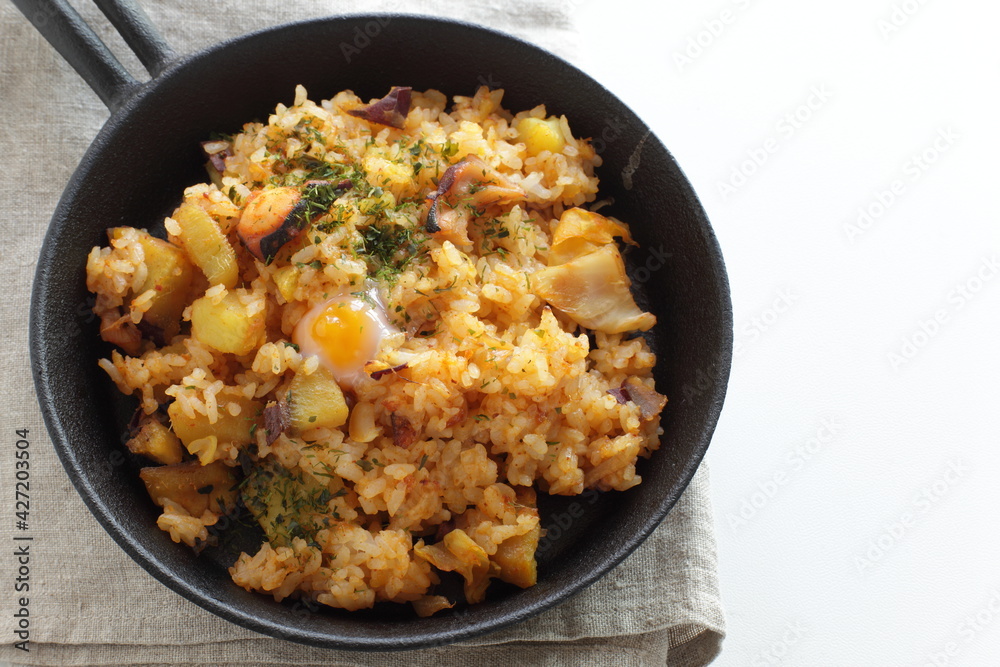 Korean food, spicy octopus fried rice in skillet pan Korean food, spicy octopus fried rice in skillet pan