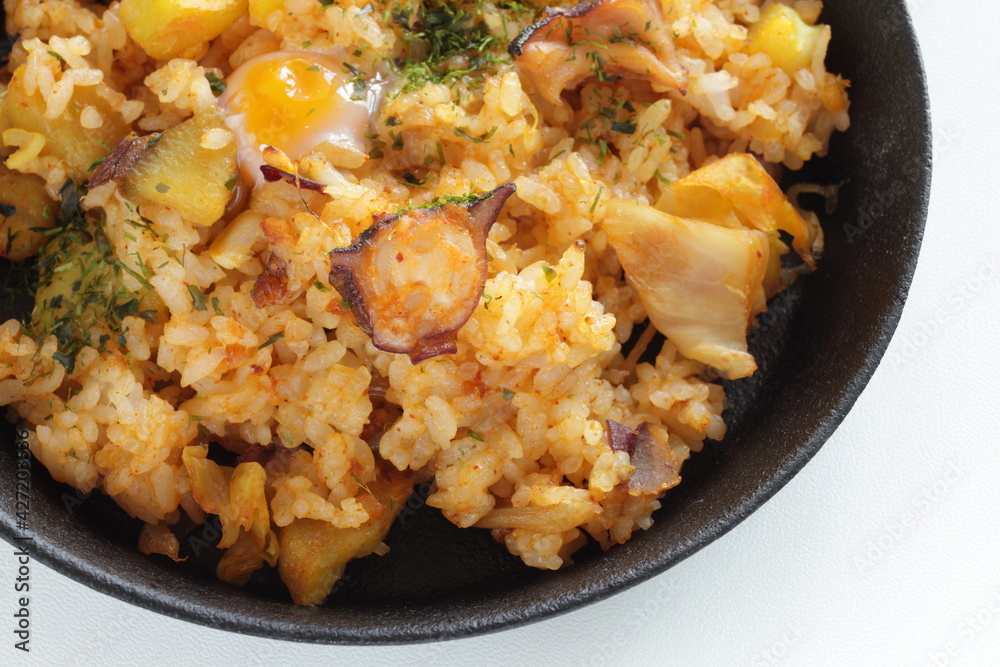 Korean food, spicy octopus fried rice in skillet pan Korean food, spicy octopus fried rice in skillet pan