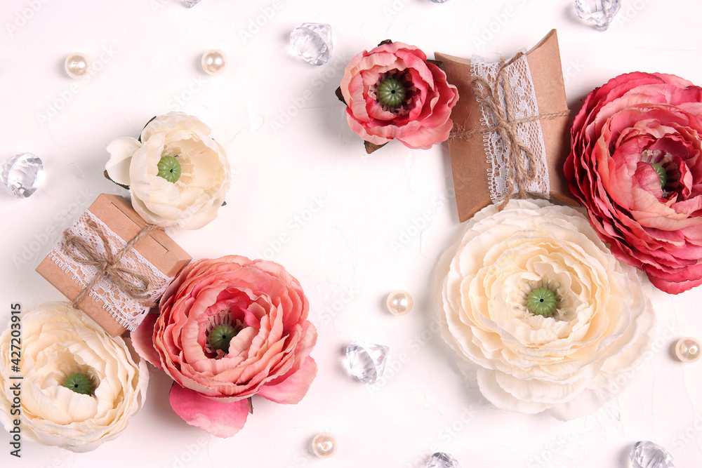 Festive romantic frame with peony flowers, gifts and crystals on white background. Festive romantic frame with peony flowers, gifts and crystals on white background.
