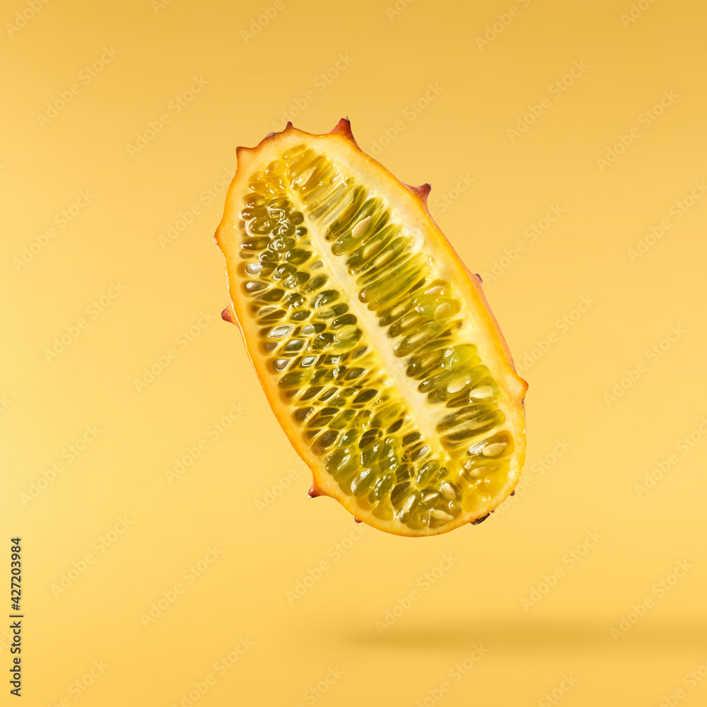 Fresh ripe kiwano falling in the air isolated Fresh ripe kiwano falling in the air isolated