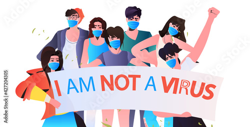 stop asian hate people in masks holding banners against racism support during coronavirus pandemic concept