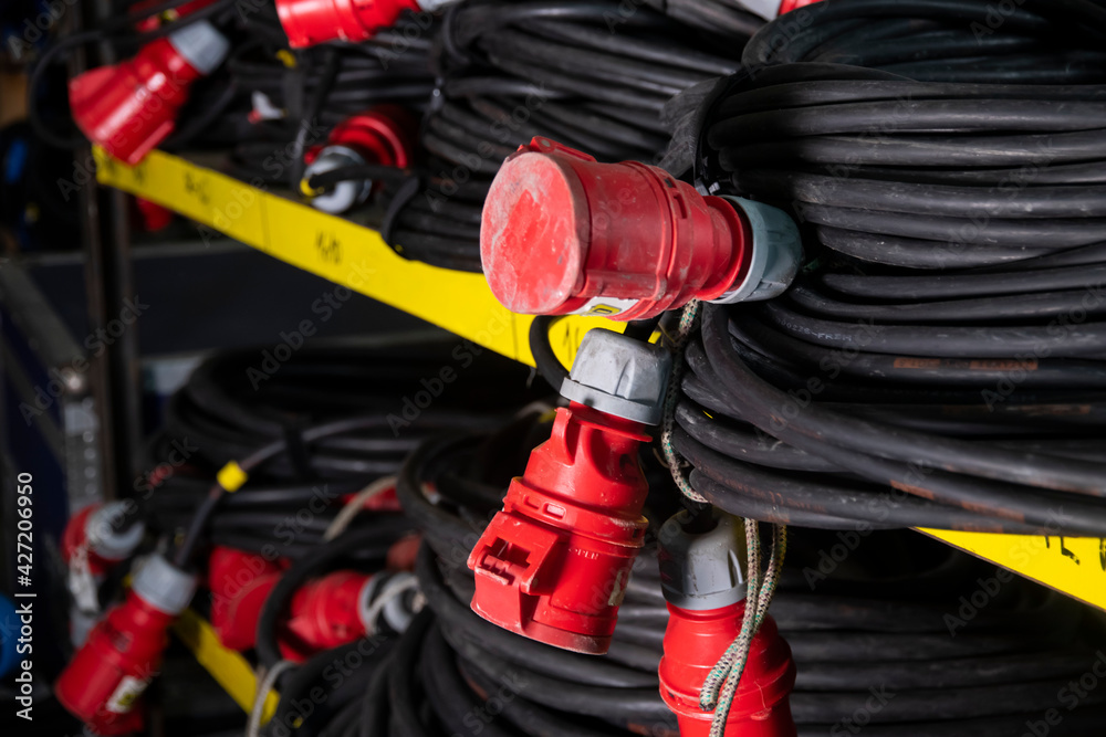 Black heavy extension cords on a shelf. Power Distributor 32A
